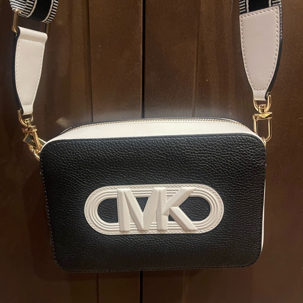 This item is a Michael Kors Jet Set Medium Camera Bag